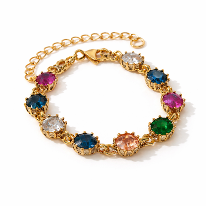 Gold bracelet with multicolored gemstones on a white background