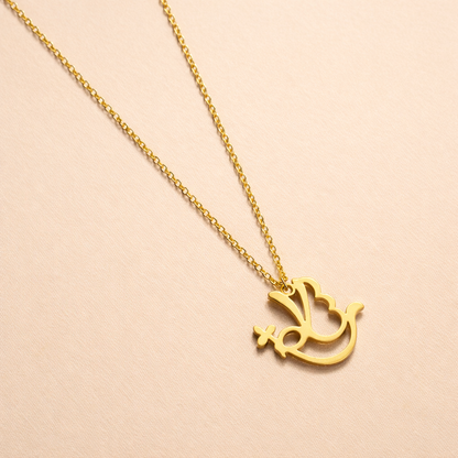 Gold necklace with a dove pendant on a beige background