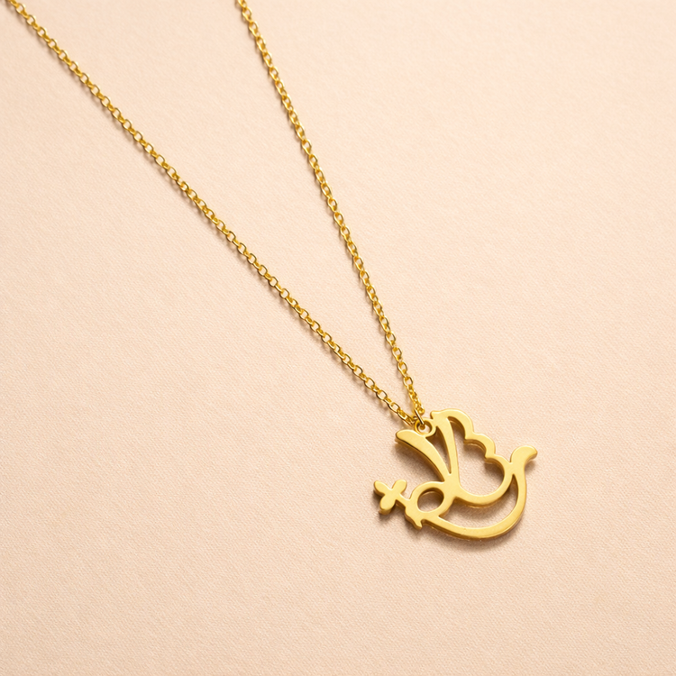 Gold necklace with a dove pendant on a beige background