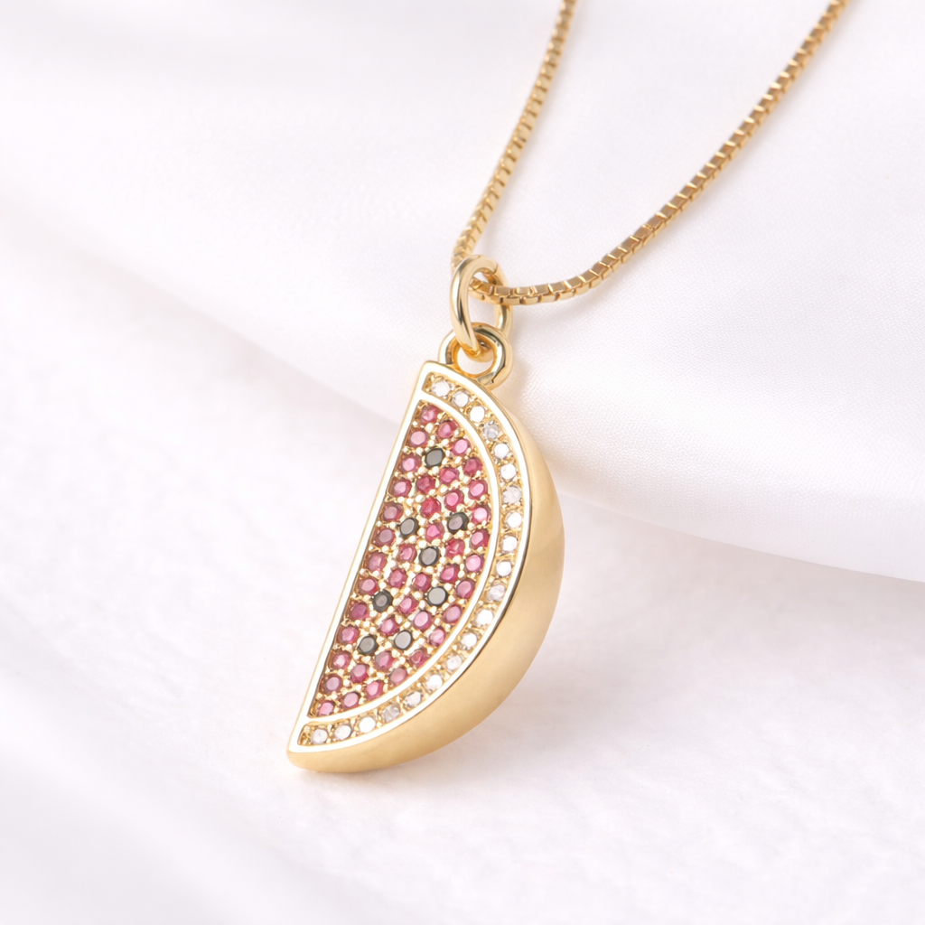 Gold necklace with a pink gemstone pendant on a white background