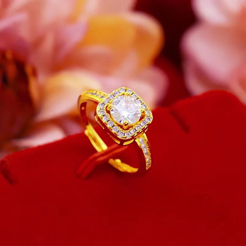 Gold ring with a diamond on a red surface