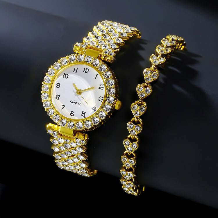 Gold watch with diamond-studded band on a black background
