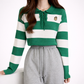 Green and white striped sweater with a logo worn by a person on a white background