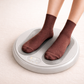Grey Massage foot warmer with text on a beige background