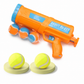 Orange tennis ball launcher with blue accents and tennis balls on a white background