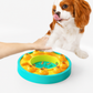 Dog playing with a colorful puzzle toy on a white background