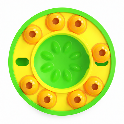 Round yellow and green toy with circular patterns on a white background