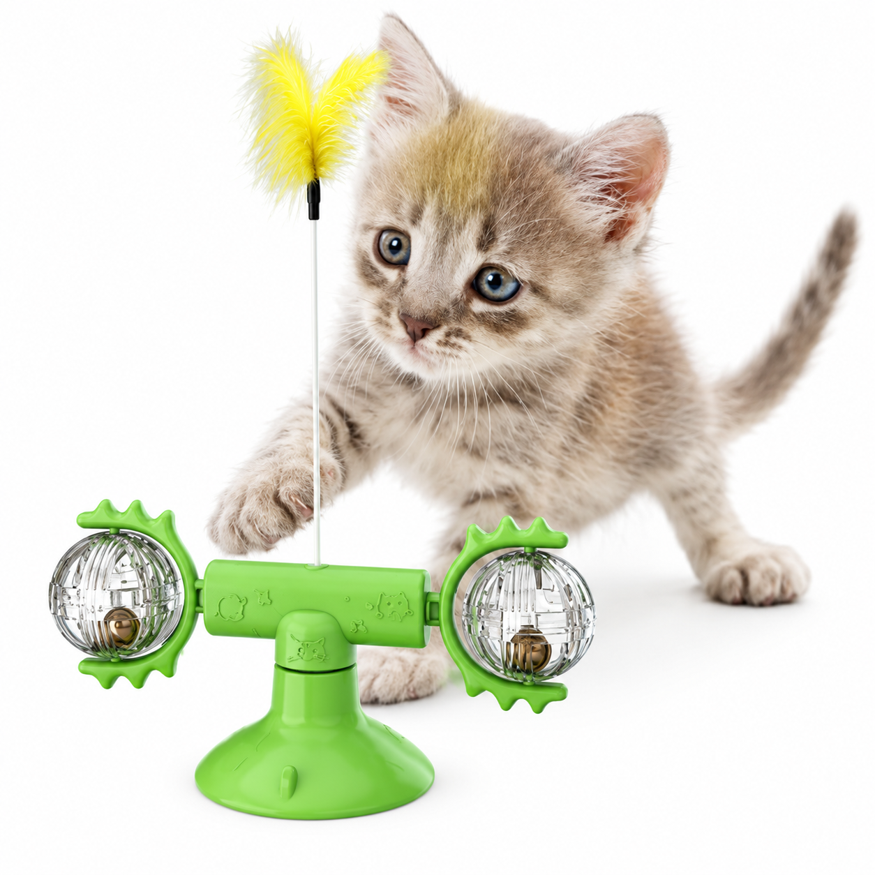 Cat toy with a yellow feather and green base next to a kitten on a white background