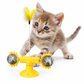 Kitten playing with a yellow cat toy on a white background