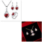 Jewelry set with red heart-shaped stones on a white background