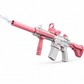 Pink and gray toy rifle with water coming out of the barrel on a white background