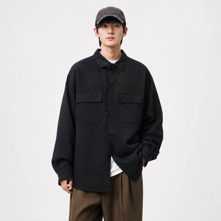 Person wearing a black jacket and brown pants on a white background