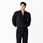 Man wearing a black outfit on a white background