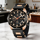 Luxury watch with black and rose gold design on a marble surface