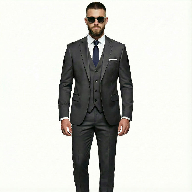 Man wearing a gray suit with sunglasses on a white background