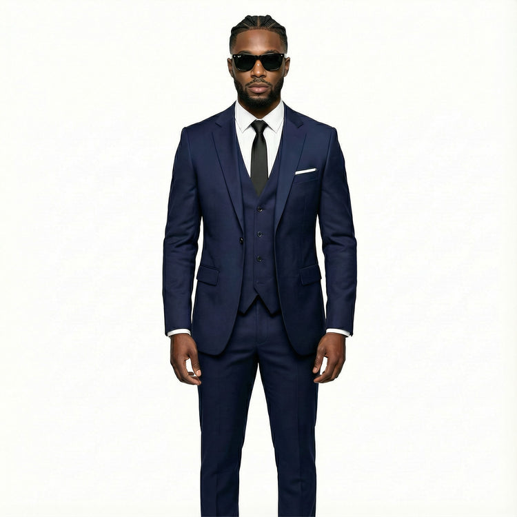 Man wearing a navy blue suit with sunglasses on a white background