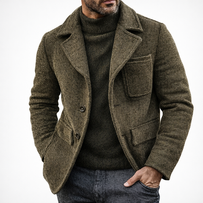 Man wearing a brown textured coat over a dark sweater on a white background