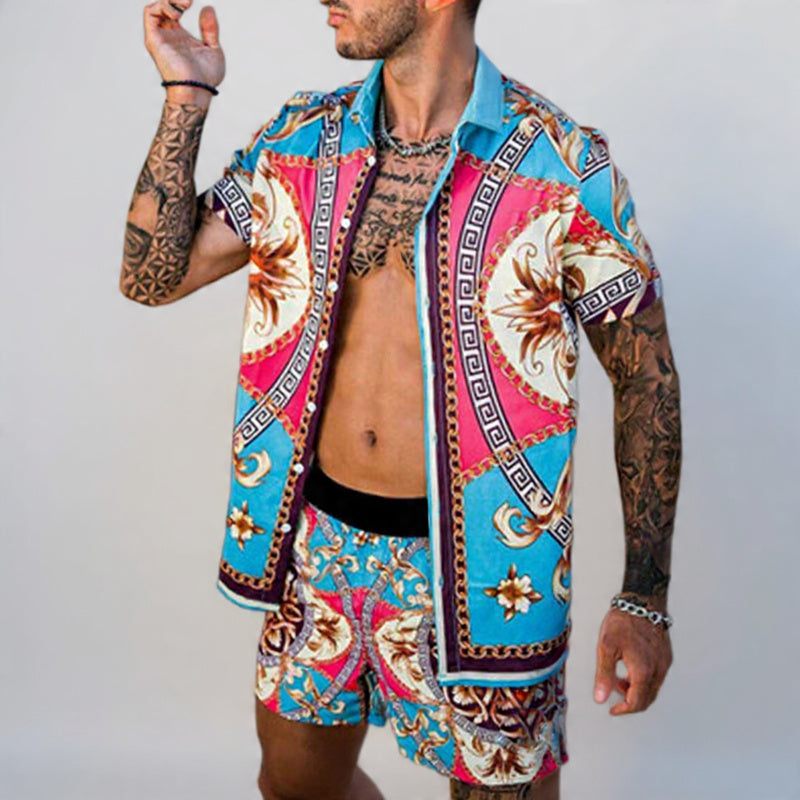 Man wearing a colorful patterned shirt and shorts on a plain background