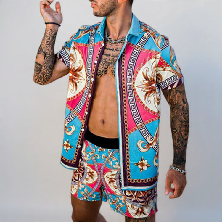Man wearing a colorful patterned shirt and shorts on a plain background