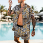 Man wearing a patterned shirt and shorts with gold chains by a poolside.