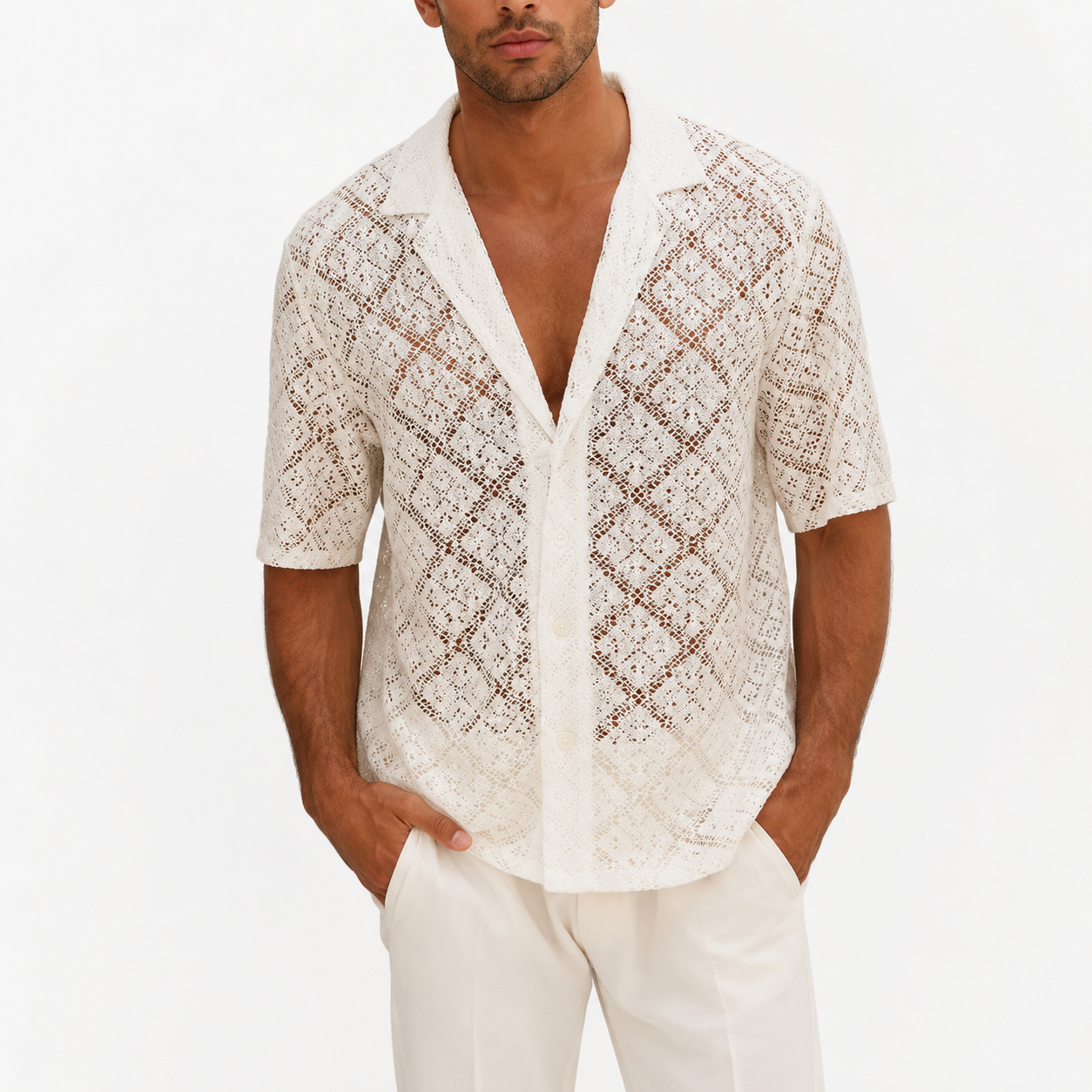 Man wearing a patterned white shirt with a plain background
