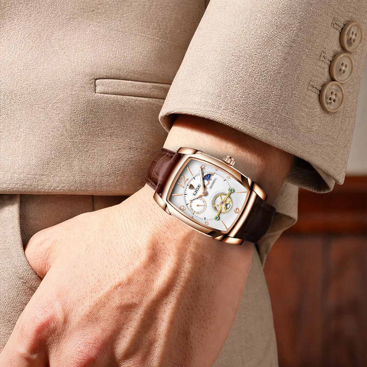 Men's square mechanical watch with calendar display, rose gold case, white face, brown leather strap on wrist