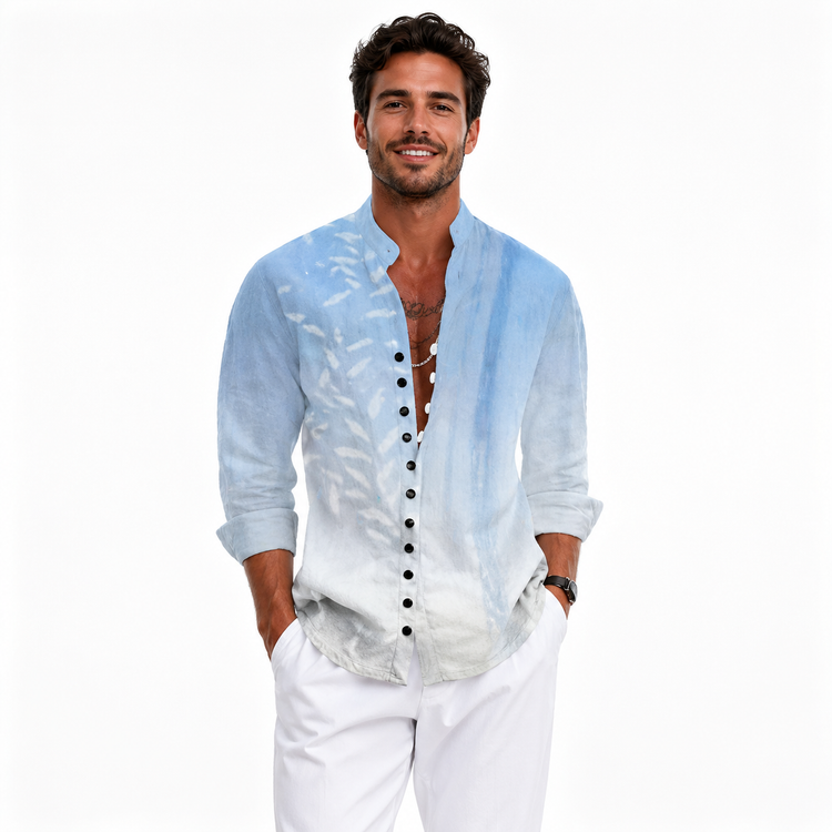 Man wearing a light blue button-up shirt with black buttons and white pants on a white background