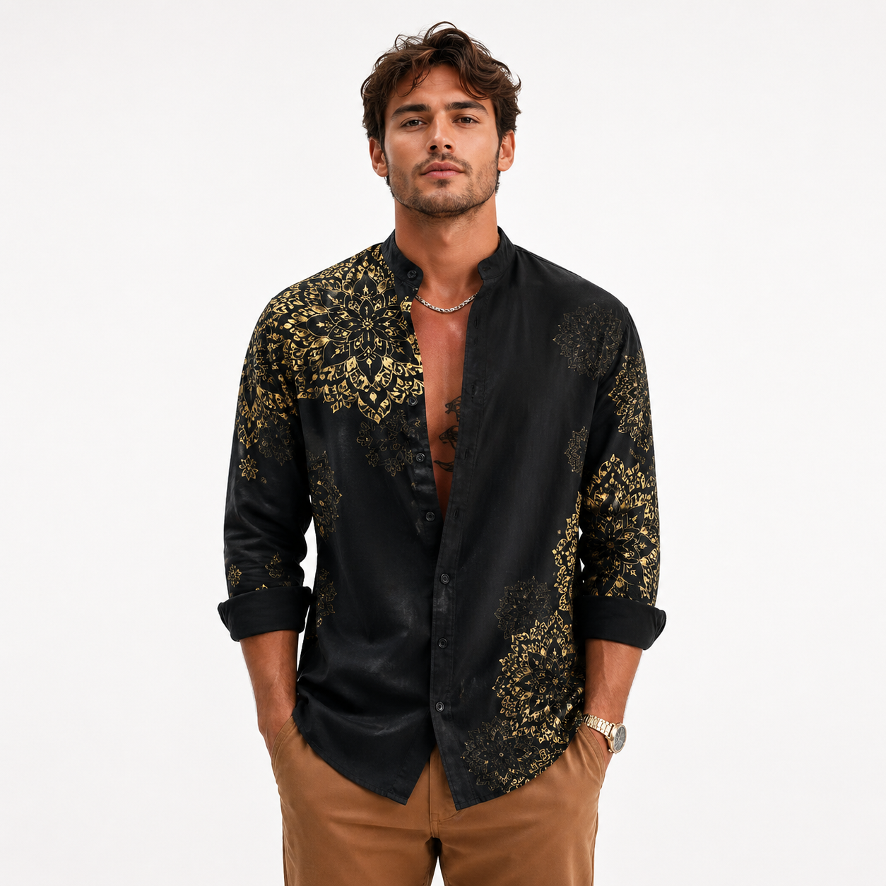 Man wearing a black shirt with gold patterns on a white background