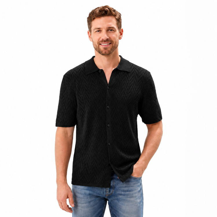 Man wearing a black textured shirt and blue jeans on a white background