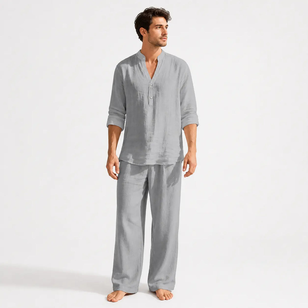 Man wearing a gray pajama set on a white background