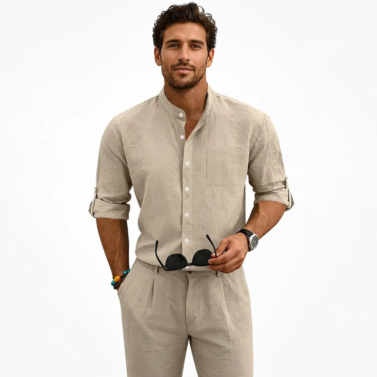 Men's linen shirt with stand-up collar in beige, worn by a model with rolled sleeves and sunglasses in hand.