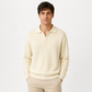 Man wearing a cream sweater and pants on a white background