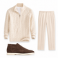 Beige cable-knit sweater, beige pants, and brown shoes on a white background