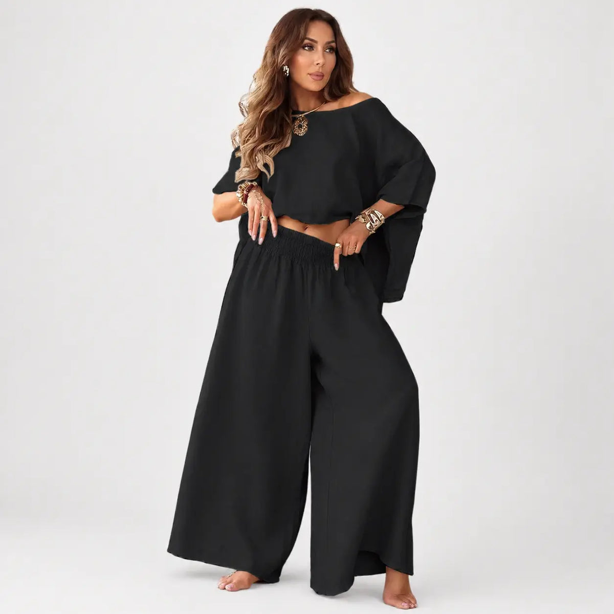Woman wearing a black outfit with a white background