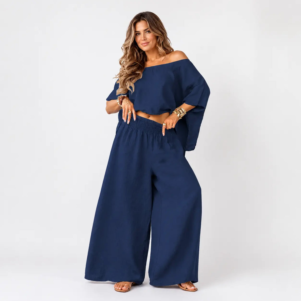 Woman wearing a navy blue outfit on a white background