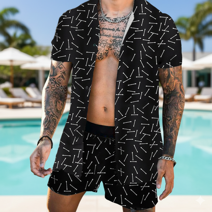 Person wearing a black patterned shirt and shorts by a poolside.