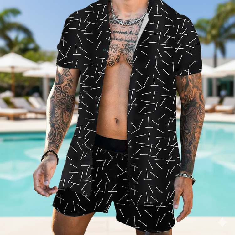 Person wearing a black patterned shirt and shorts by a poolside.