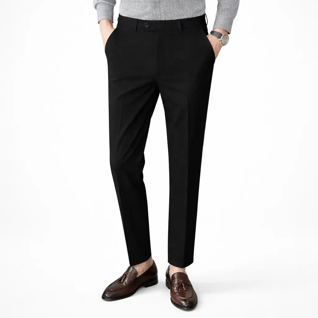 Person wearing black dress pants with a white background