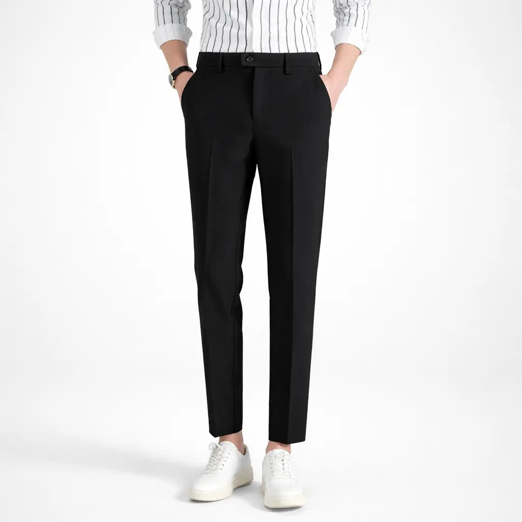 Men's casual sports pants, slim fit black cotton blend front view on male model with white sneakers