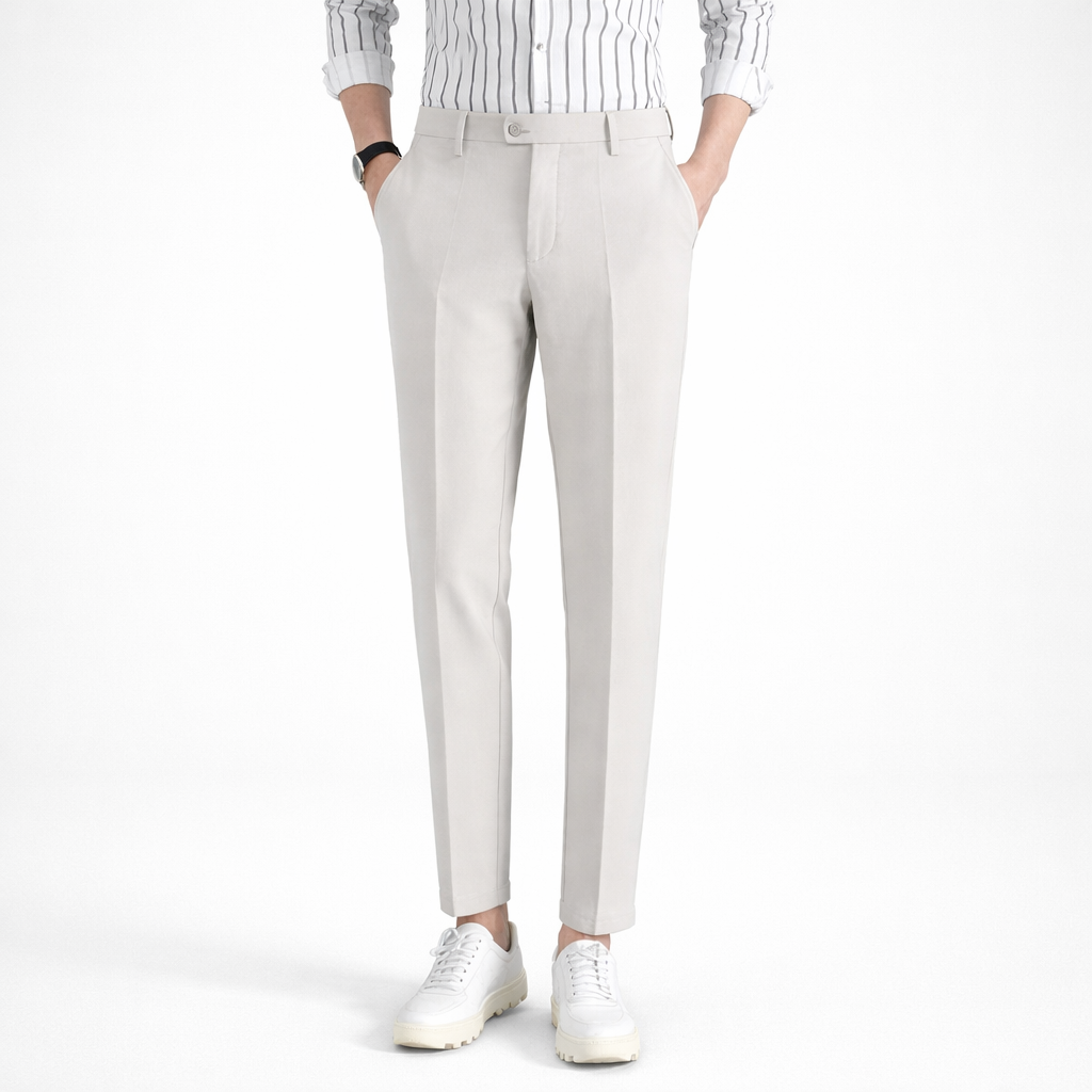 Person wearing light gray pants and a striped shirt on a white background