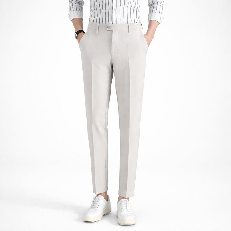 Person wearing light gray pants and a striped shirt on a white background