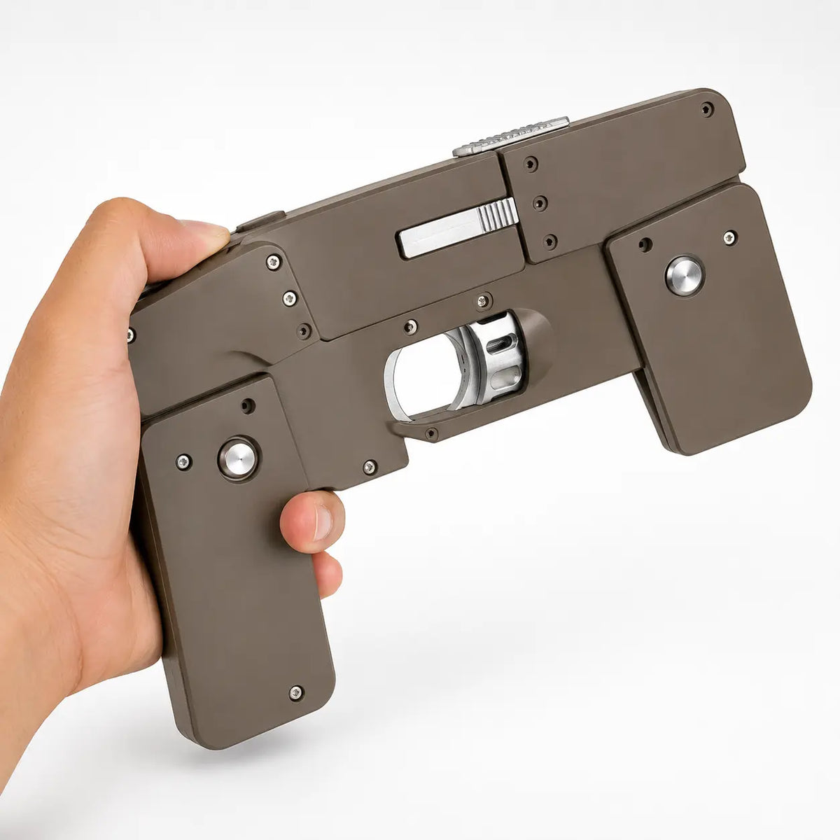 Mobile phone-shaped foldable toy gun held in hand, showing gray color and side details.