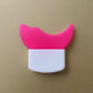 Pink and white device with a cat ear design on a beige background
