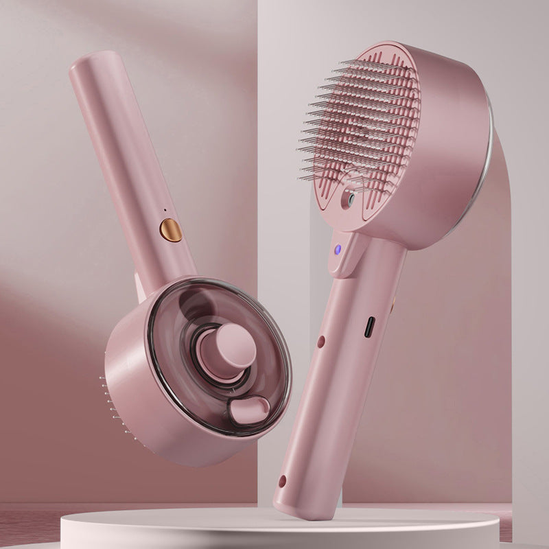 Pink handheld hair care device with brush and nozzle on a white background
