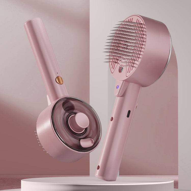 Pink handheld hair care device with brush and nozzle on a white background