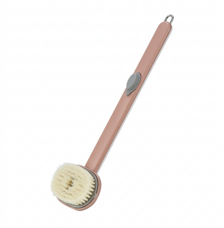 Pink scrubbing brush with a round head on a white background