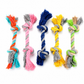 Five colorful knotted rope toys on a white background