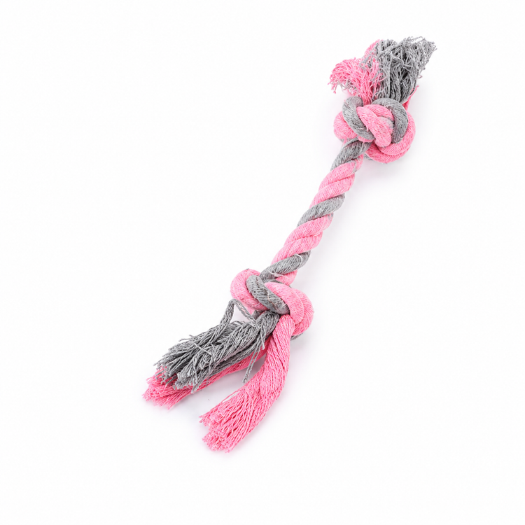 Pink and gray knotted rope toy on a white background