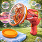 Red dragon-shaped bubble gun with orange handle on grass with bubbles