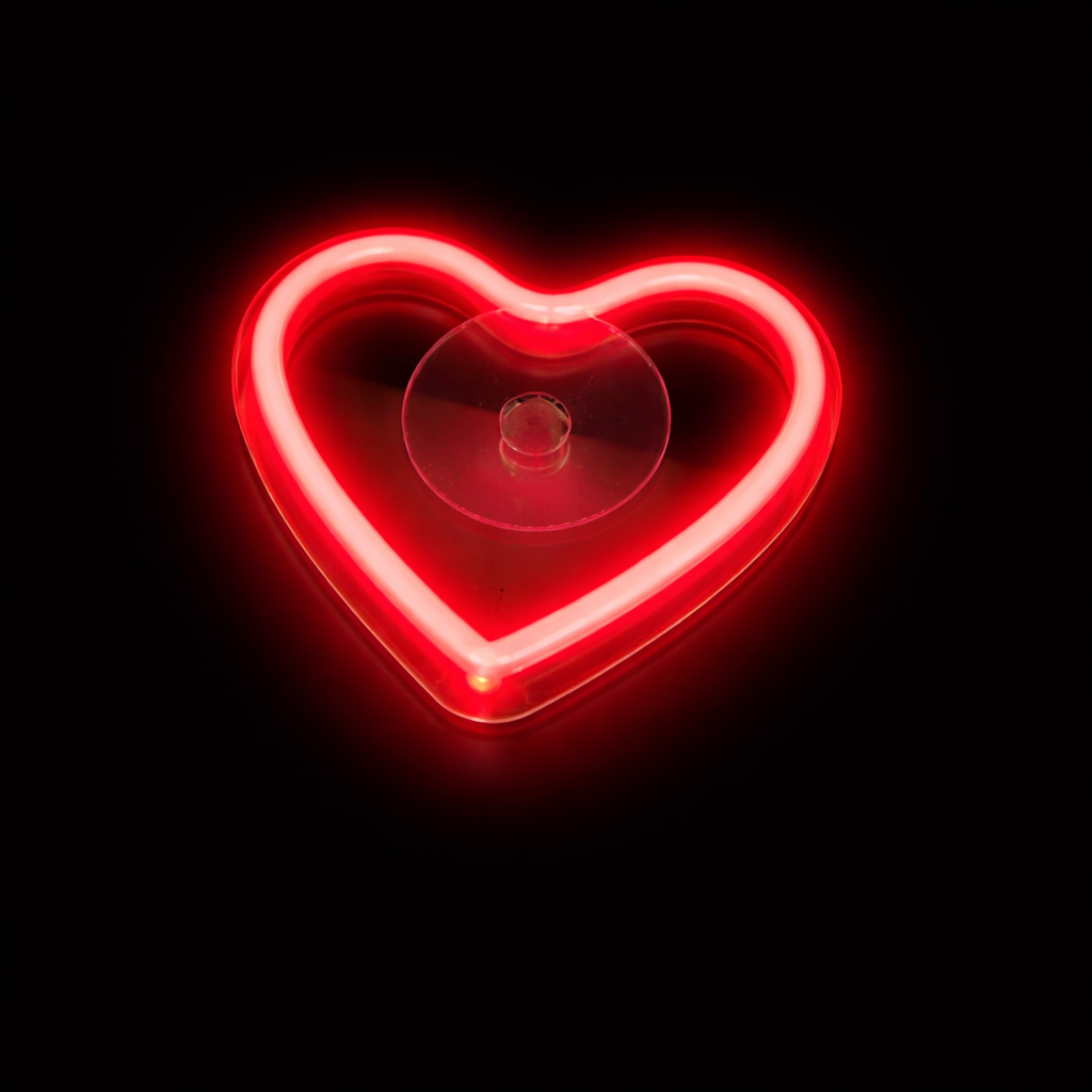 Red heart-shaped neon light on a black background